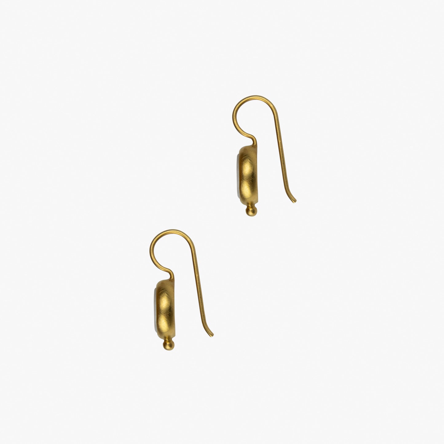 Die vergoldeten Ohrhänger aus Sterlingsilber tragen das Ohm Symbol in Porzellan geprägt